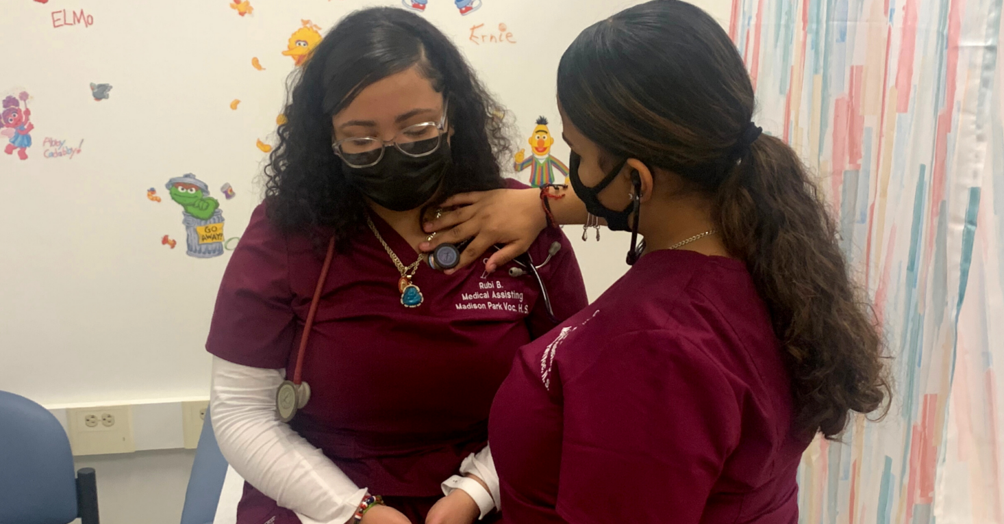Madison Park Medical Assisting students practice on each other.